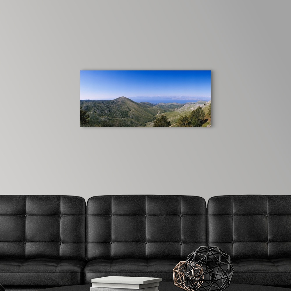 A modern room featuring Mountain range with a sea in the background, Corfu, Ionian Islands, Greece