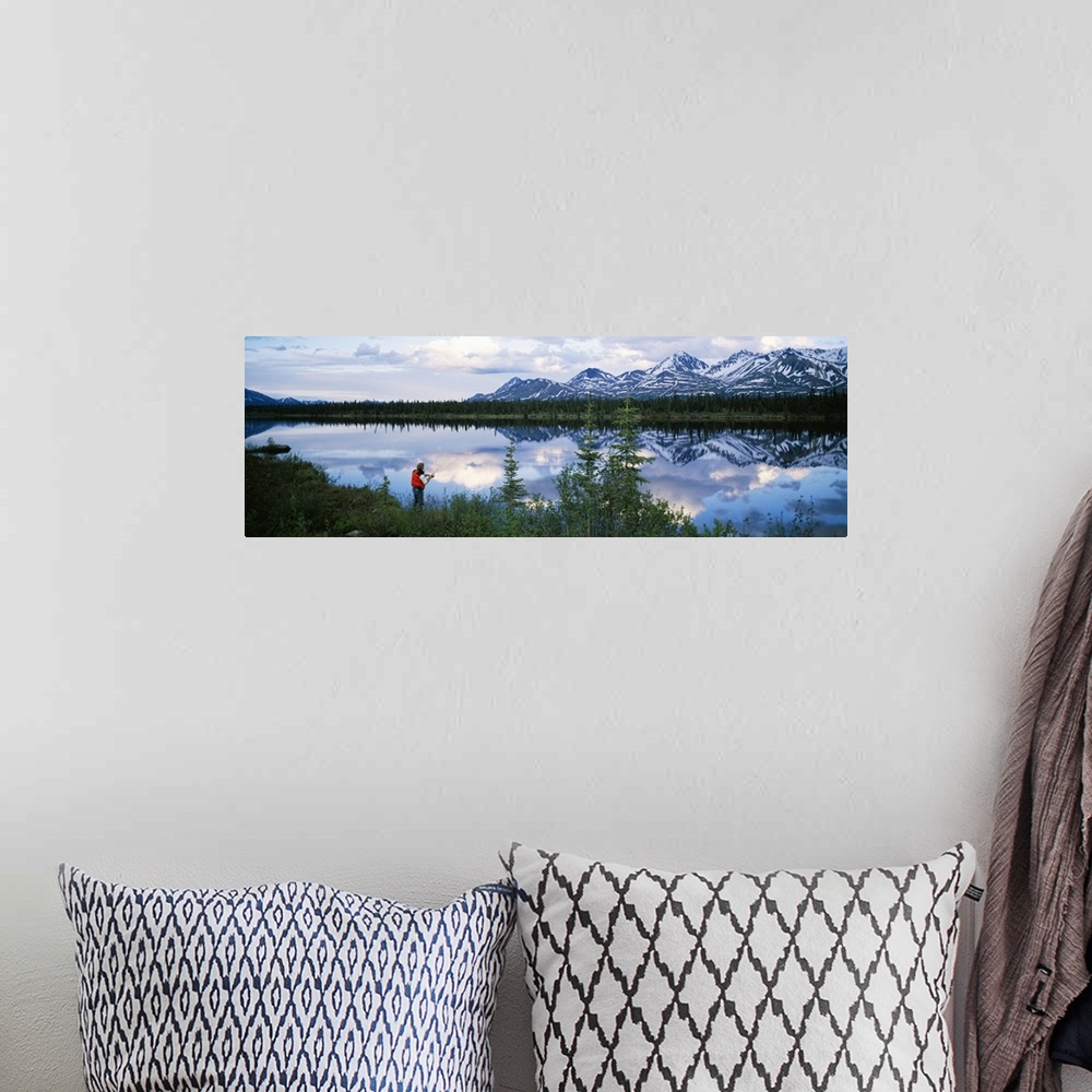 A bohemian room featuring Mountain scene with lake reflection, fisherman at water's edge, spring, Alaska Range, Alaska