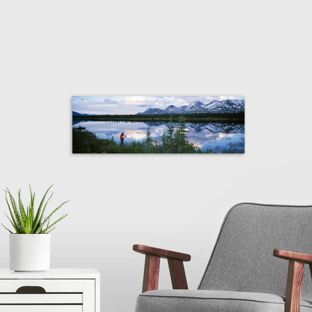 A modern room featuring Mountain scene with lake reflection, fisherman at water's edge, spring, Alaska Range, Alaska