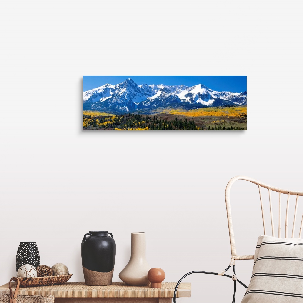 A farmhouse room featuring Panoramic image of a wilderness area at the base of a snowy mountain range.