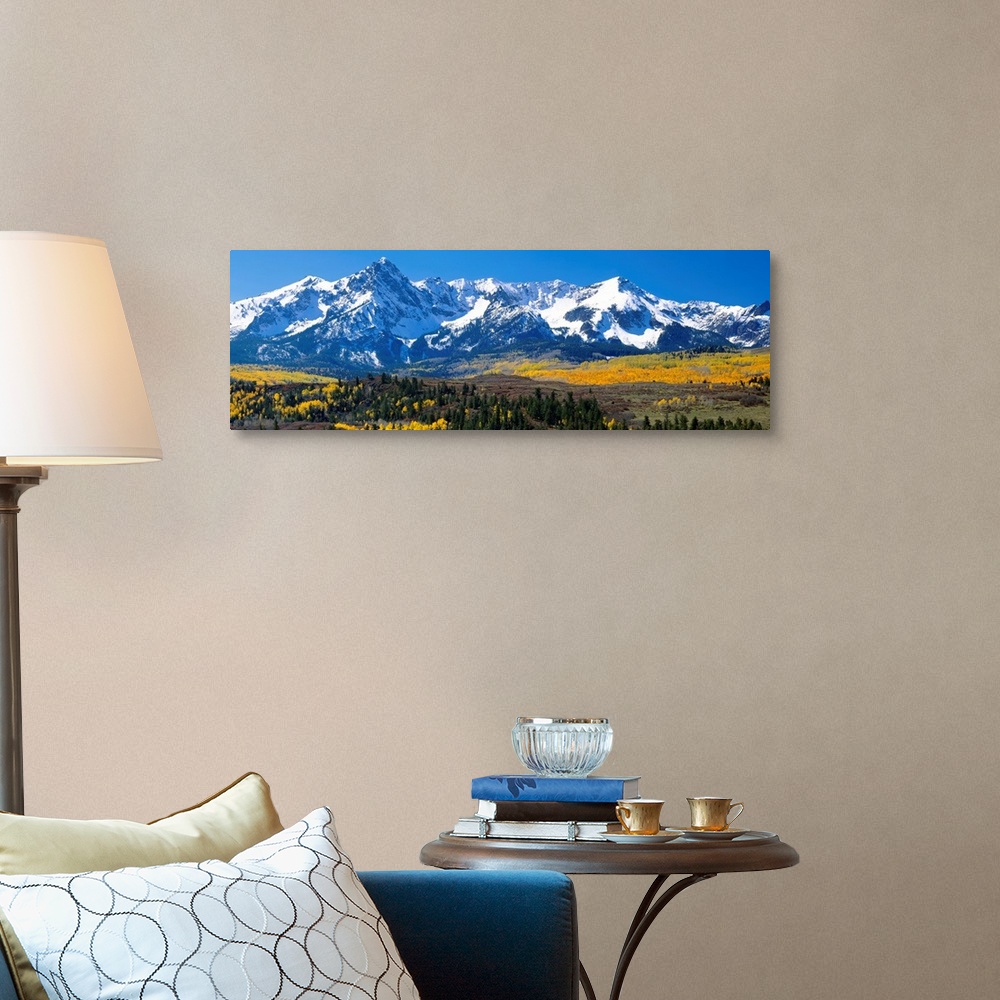 A traditional room featuring Panoramic image of a wilderness area at the base of a snowy mountain range.