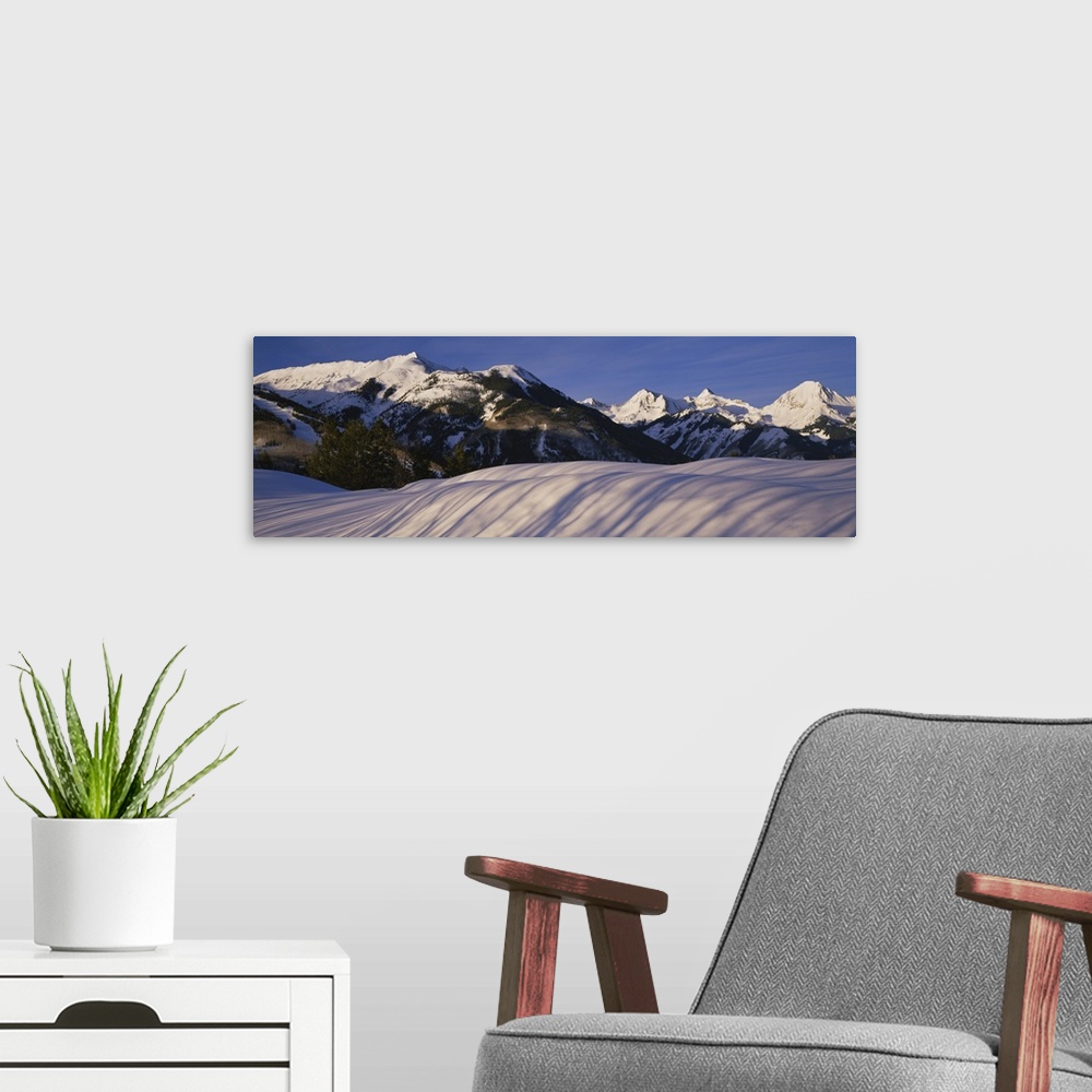 A modern room featuring Mountains covered with snow, Snowmass Mountain on left, Capitol Peak on right, Elk Mountains, Sno...