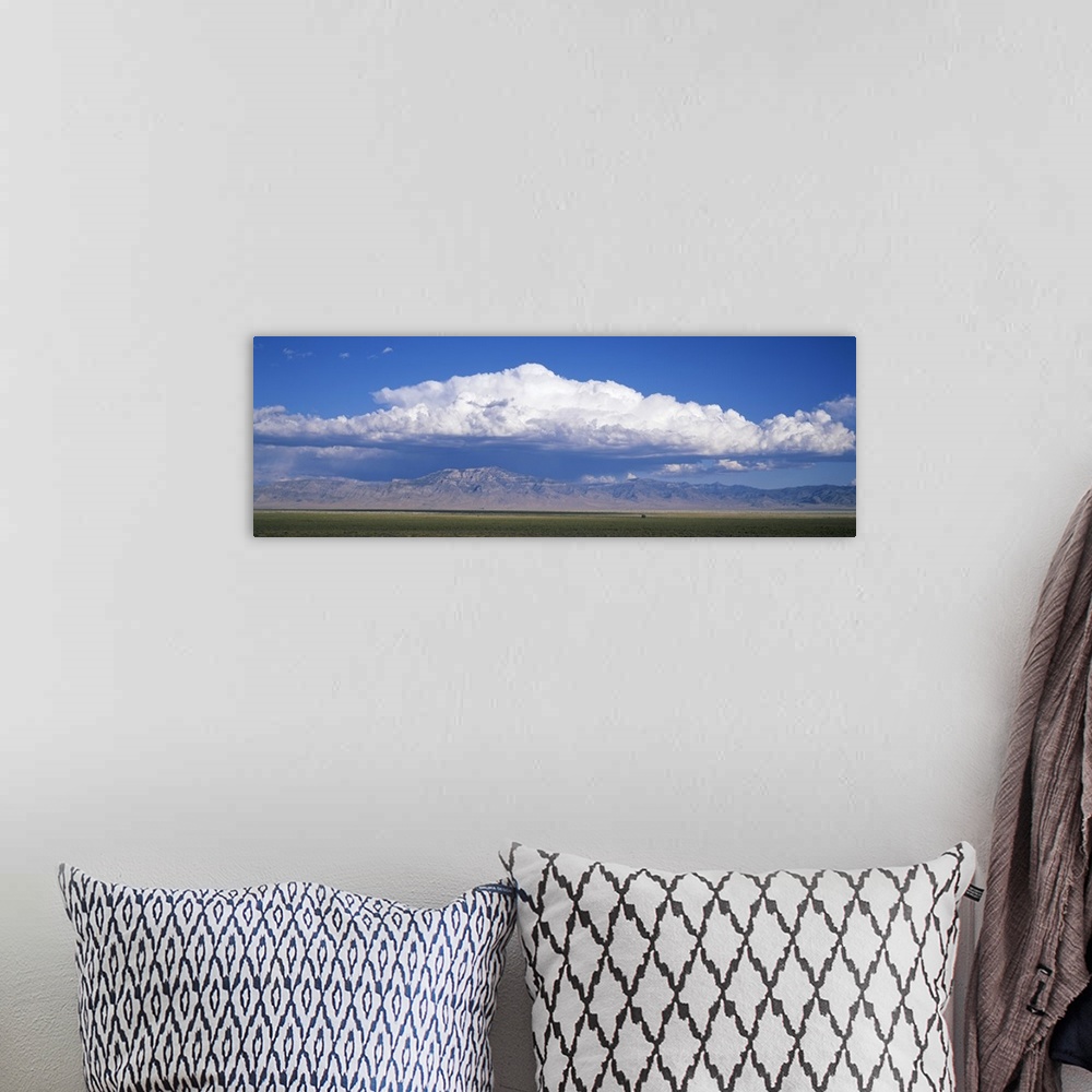 A bohemian room featuring Mountains w\ cumulus clouds NV