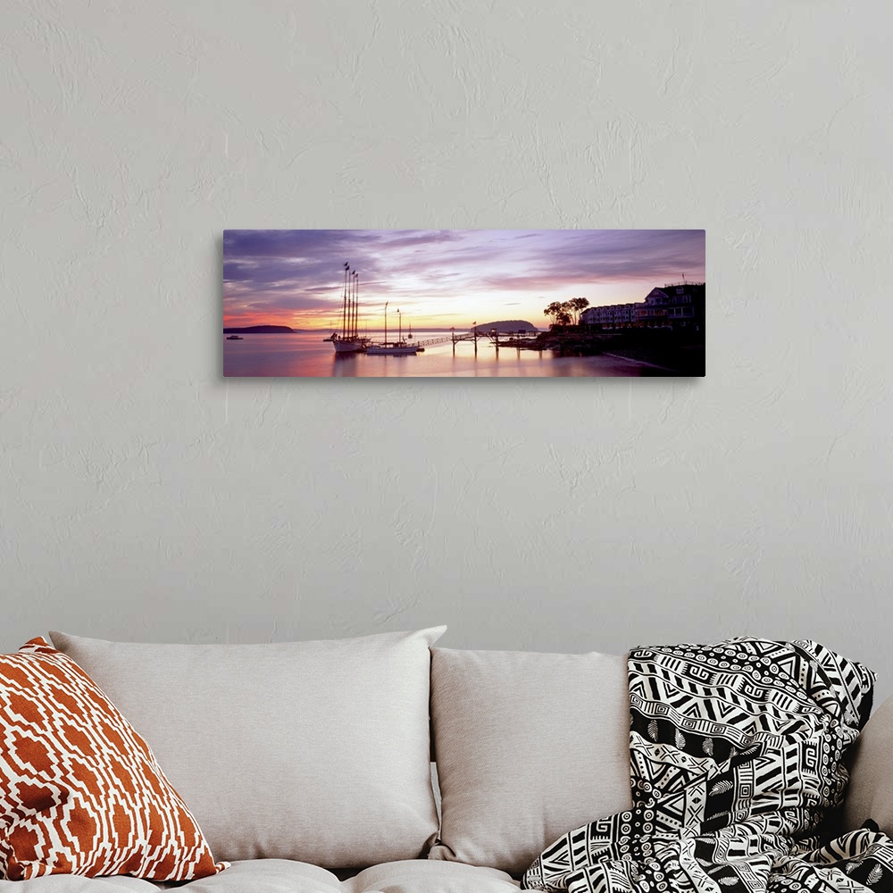 A bohemian room featuring Panoramic photograph sailboats at dock under a cloudy sunset with mountain silhouettes in the dis...