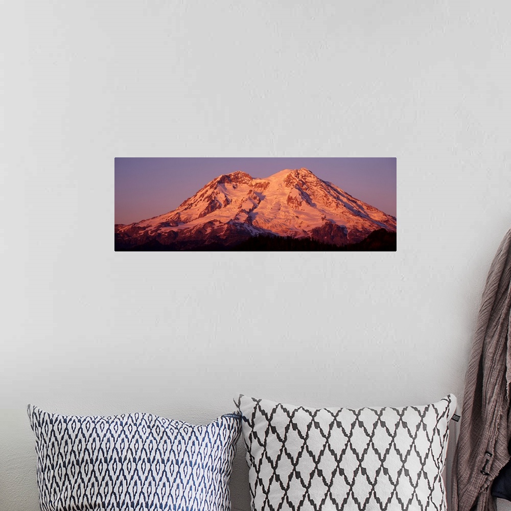 A bohemian room featuring Panoramic print of Mt. Rainier bathed in warm sunlight.
