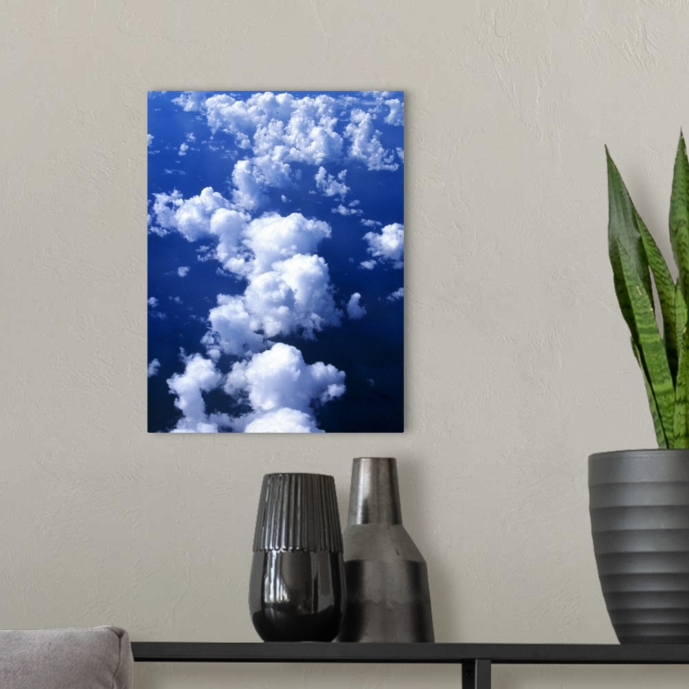 A modern room featuring Multiple white clouds, blue sky.