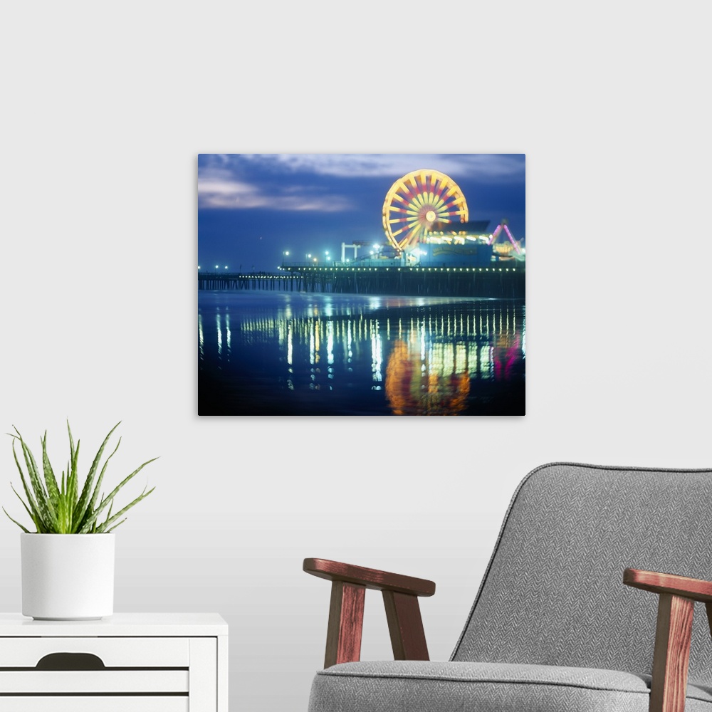 A modern room featuring Landscape, large photograph of Municipal Pier at night, reflecting in the waters in the foregroun...