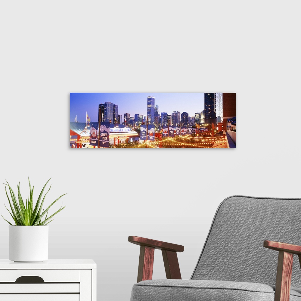 A modern room featuring Panoramic photograph of dock at night with city skyline in the background.  The dock is strung wi...
