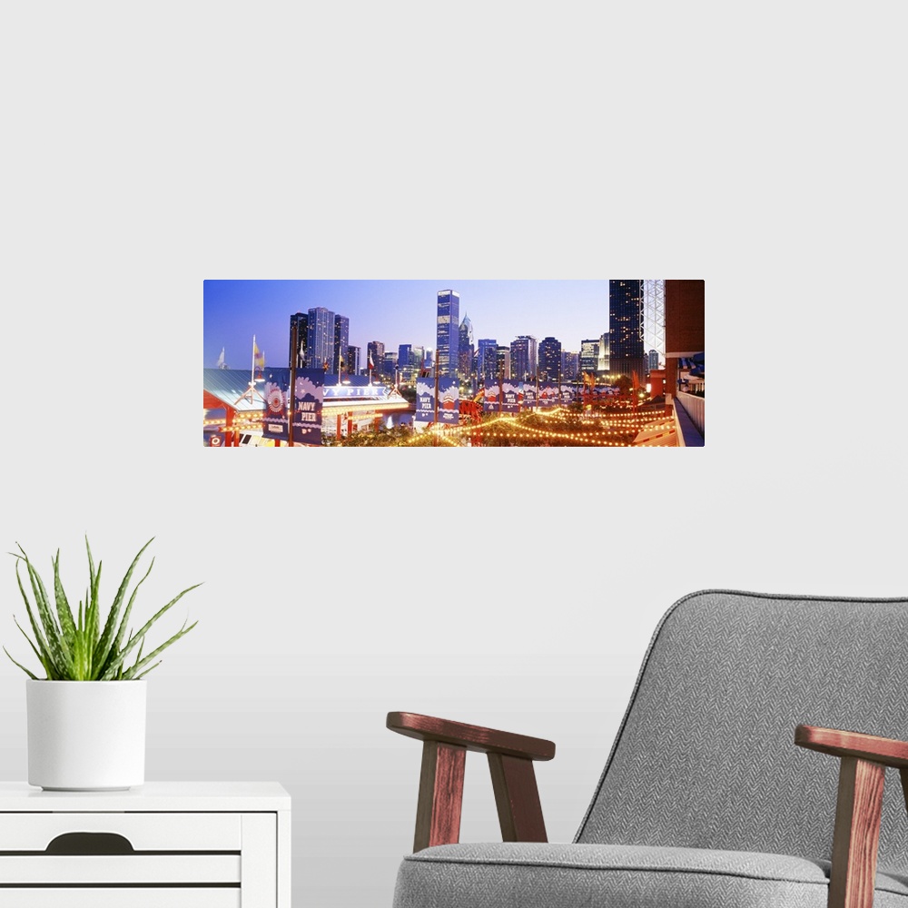 A modern room featuring Panoramic photograph of dock at night with city skyline in the background.  The dock is strung wi...