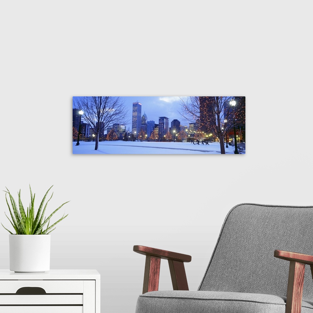 A modern room featuring Panoramic photograph of the Navy Pier Park at dusk lit up for the holidays in Chicago, Illinois.