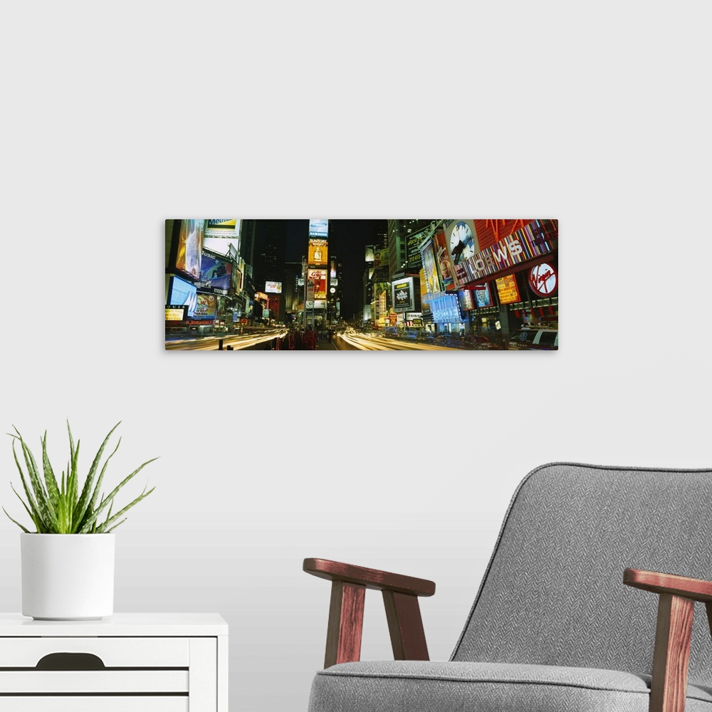 A modern room featuring Wide angle photograph of Times Square in New York City, brightly lit at night.