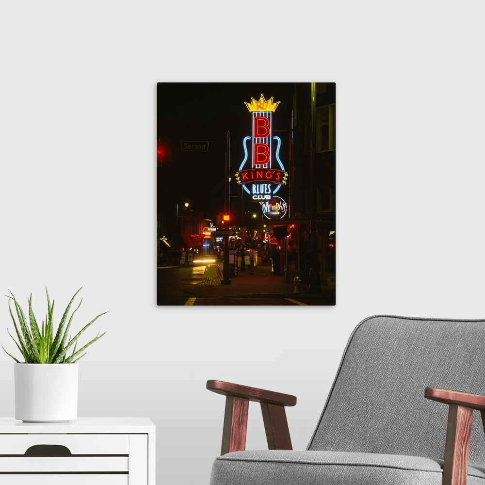 A modern room featuring Vertical, large photograph of the street corner featuring the B.B. King's Blues Club neon sign, l...