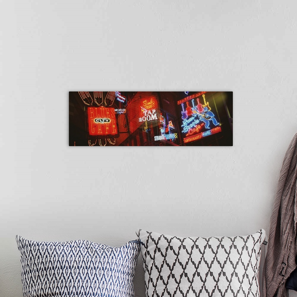 A bohemian room featuring Panorama of Memphis nightlife neon signs.