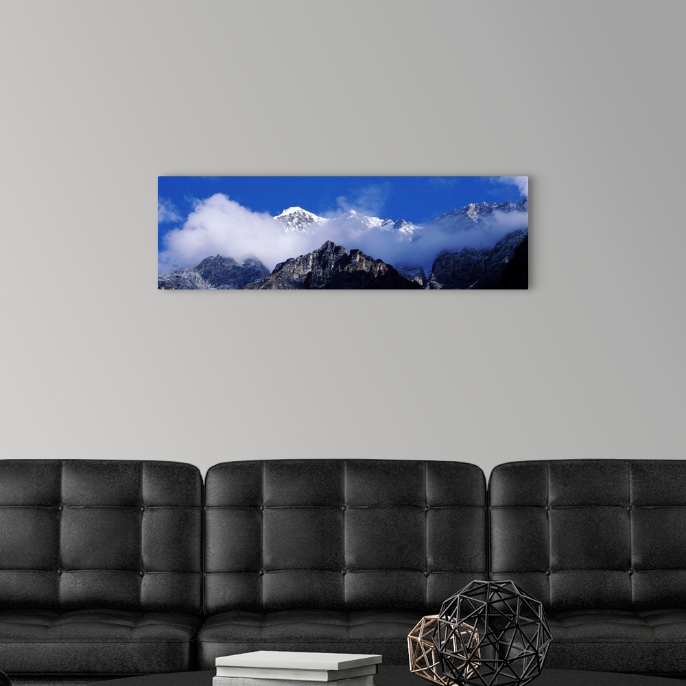 A modern room featuring Nepal, Manaslu Trek, Low angle view of clouds around mountain peaks