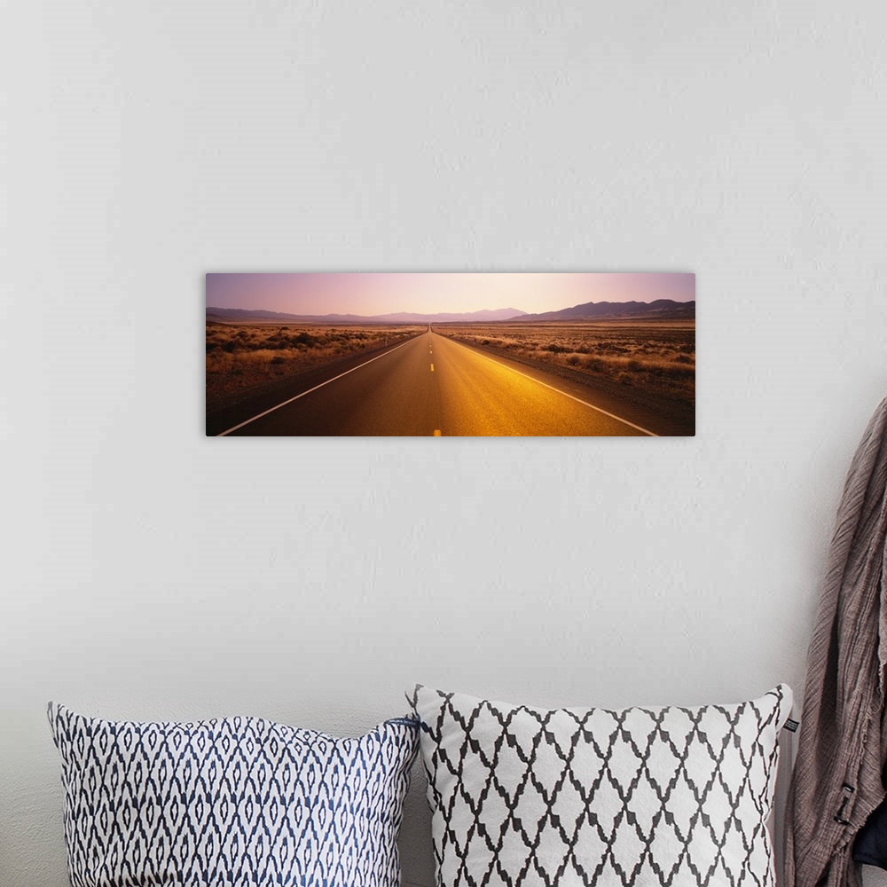 A bohemian room featuring Long horizontal canvas photo of a long two lane road going straight into the distance of a desert...
