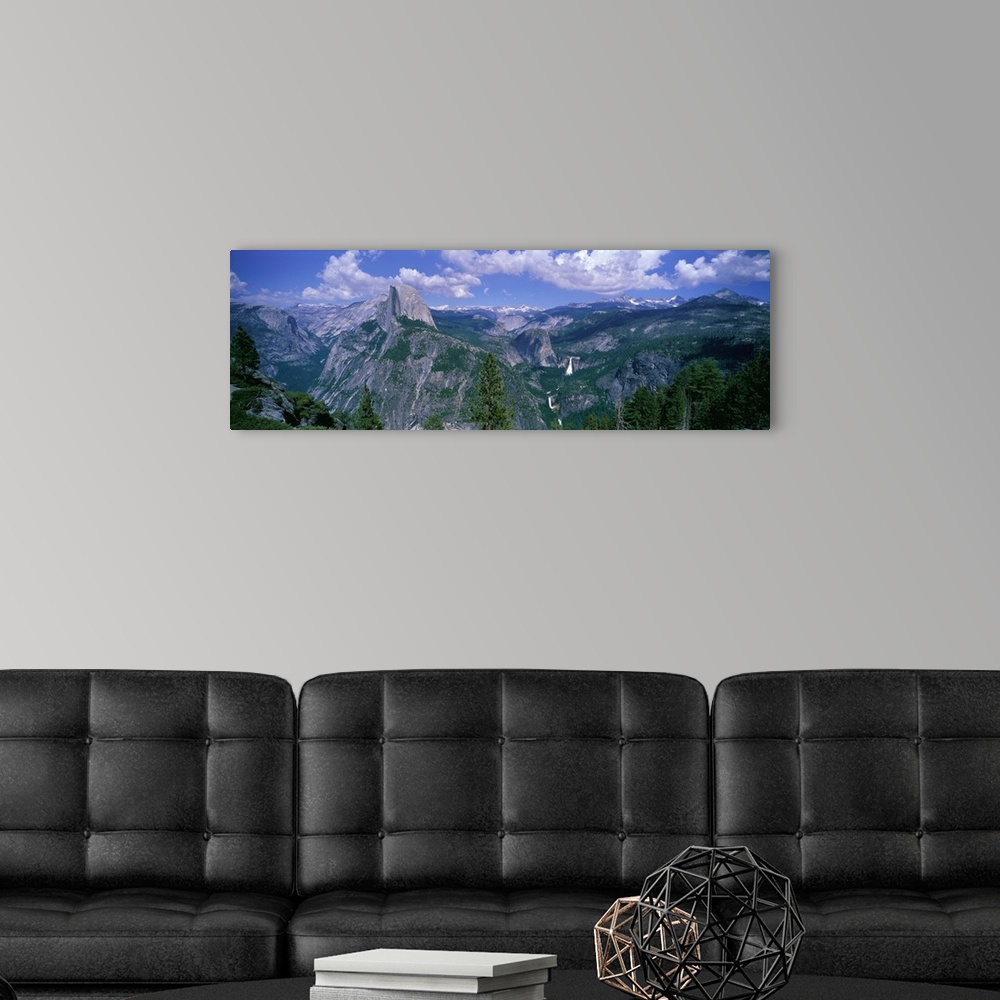 A modern room featuring Panoramic photograph taken from an aerial view overlooking a giant mountain range scattered with ...
