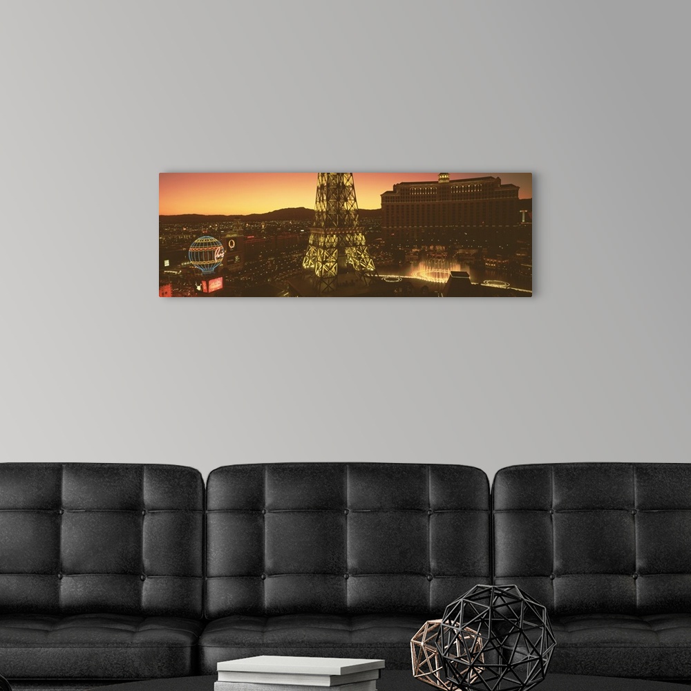 A modern room featuring Panoramic photograph from a high angle of Las Vegas at night, including Paris, the Eiffel Tower a...
