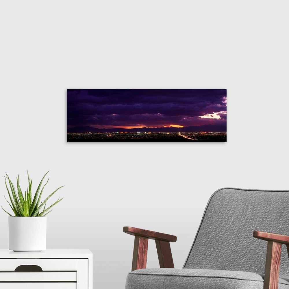 A modern room featuring Artwork for the home or office of the Las Vegas strip photographed from a distance with purple to...