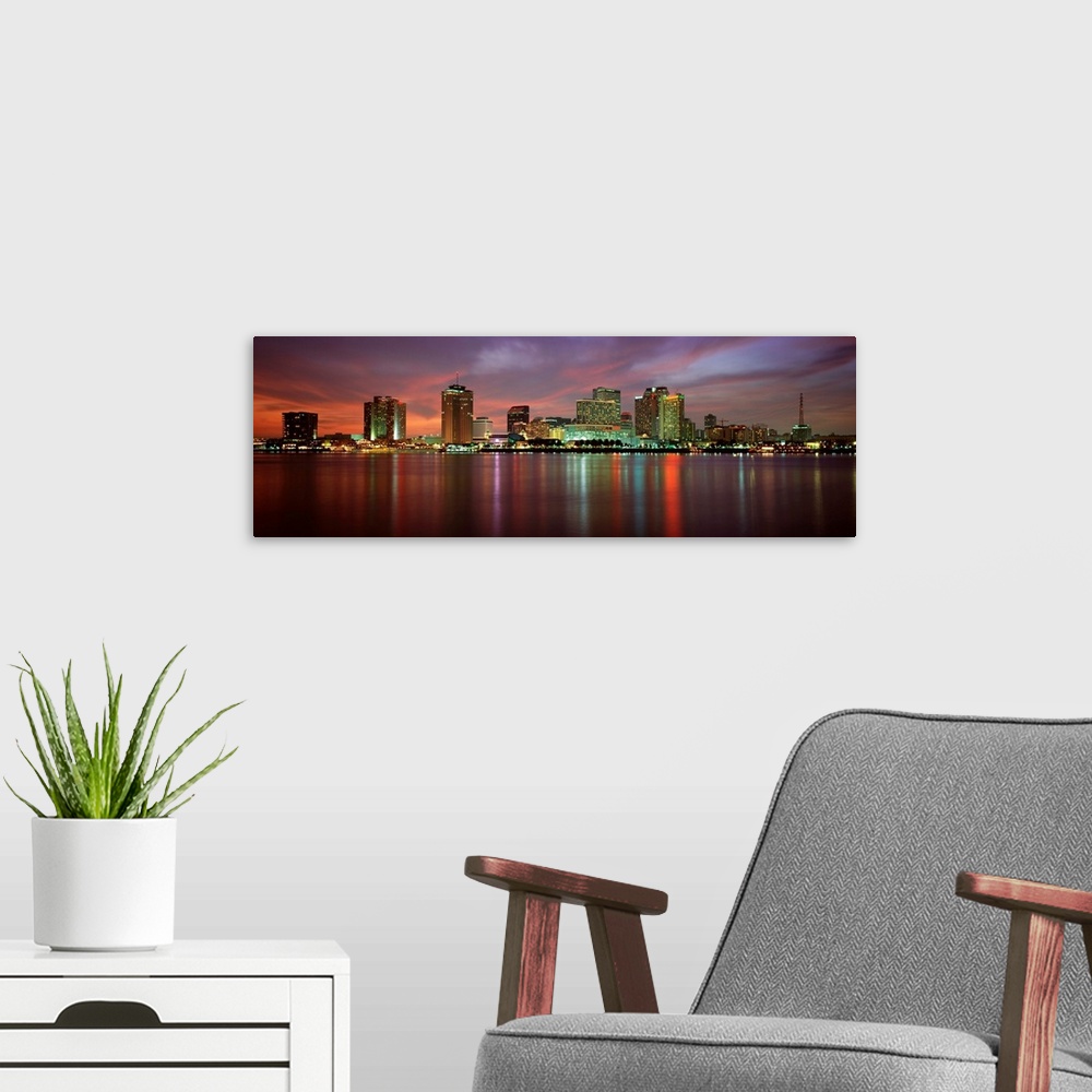 A modern room featuring Panoramic photograph of the Crescent City skyline at twilight reflecting in the water.
