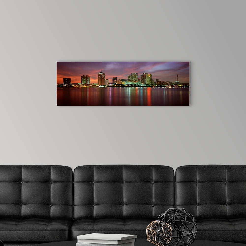 A modern room featuring Panoramic photograph of the Crescent City skyline at twilight reflecting in the water.
