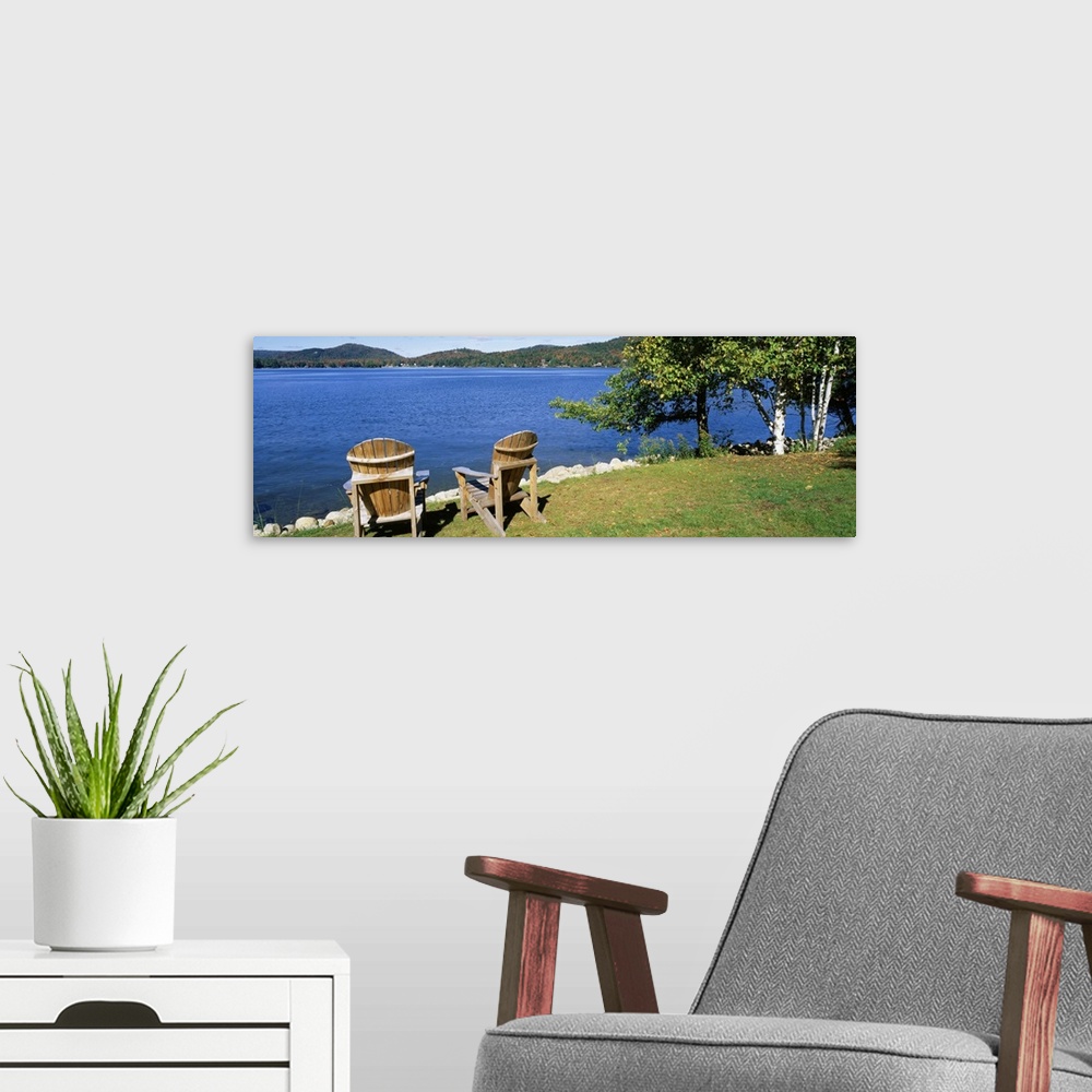 A modern room featuring New York, Adirondack State Park, Adirondack Mountains, Fourth Lake, Adirondack Chairs on a lawn