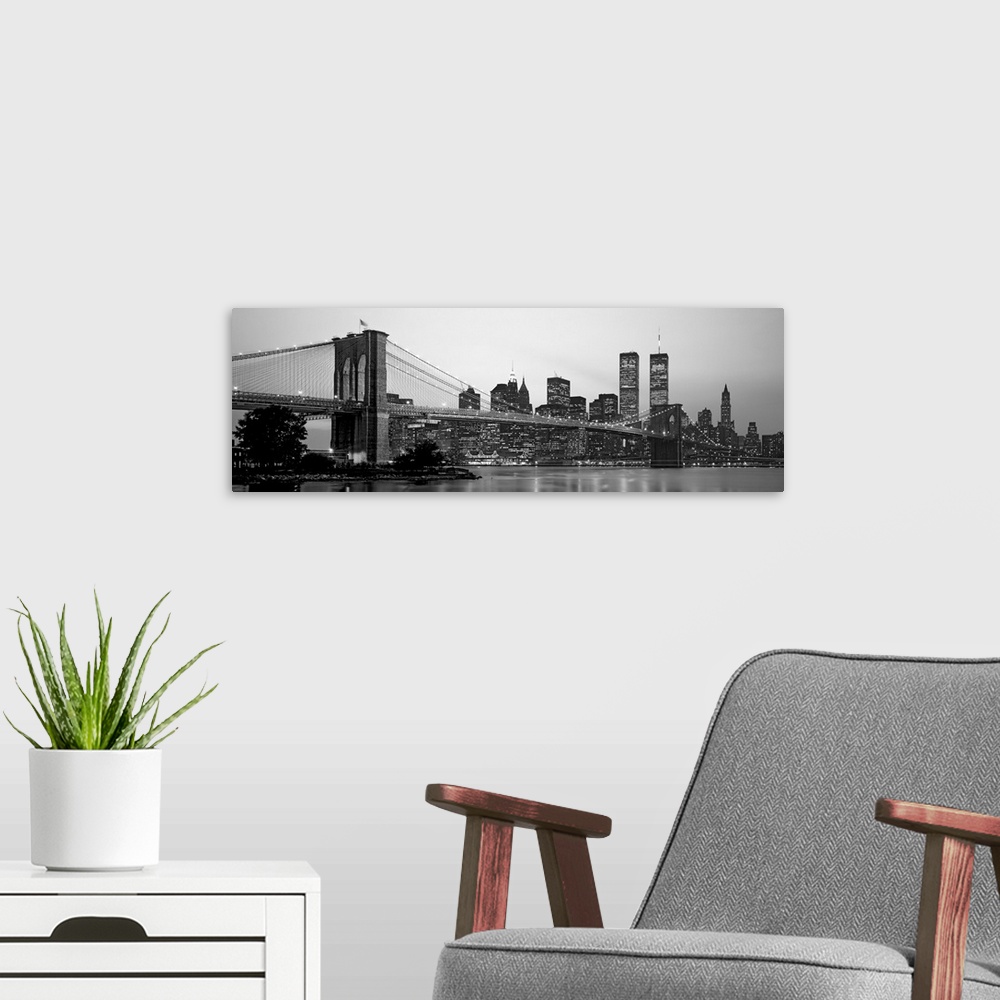 A modern room featuring Panoramic photograph of the Brooklyn Bridge against a skyline filled with skyscrapers in New York...