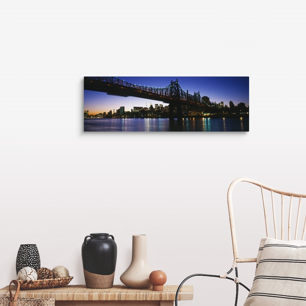A farmhouse room featuring Big, panoramic photograph of the 59th Street Bridge, lit at night, the New York City skyline in t...