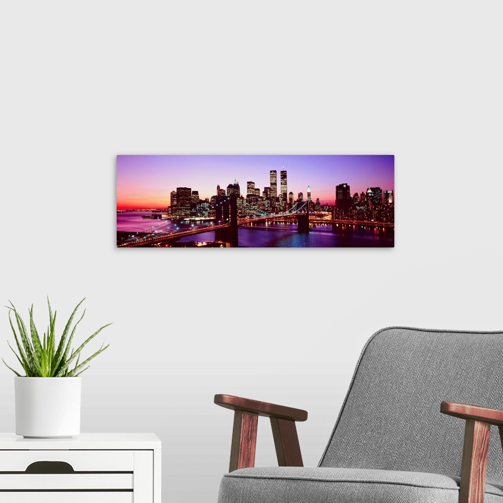 A modern room featuring Large artwork for a living room of office of the Brooklyn Bridge and Manhattan with lights shinin...