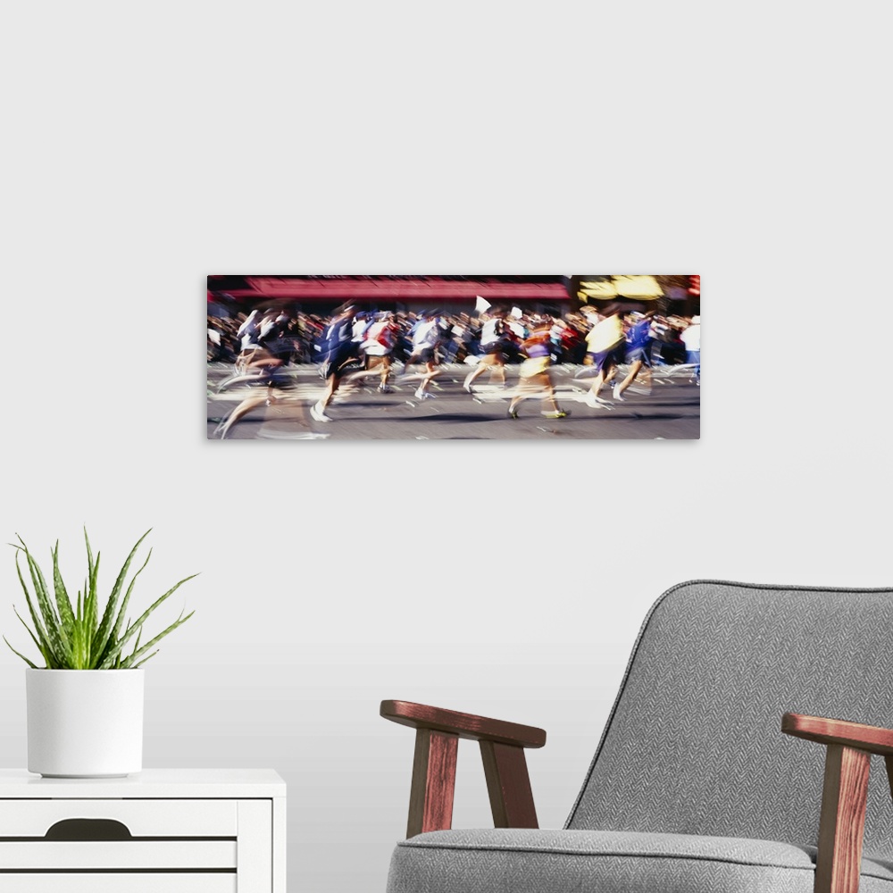 A modern room featuring This panoramic shot is taken of runners in motion during a marathon so everyone appears blurry.