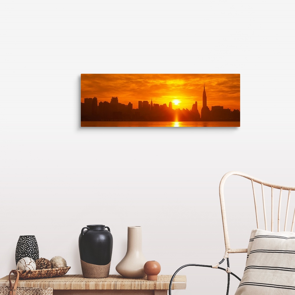 A farmhouse room featuring This panoramic photograph shows the sun rising over Manhattan and making silhouettes of the city ...