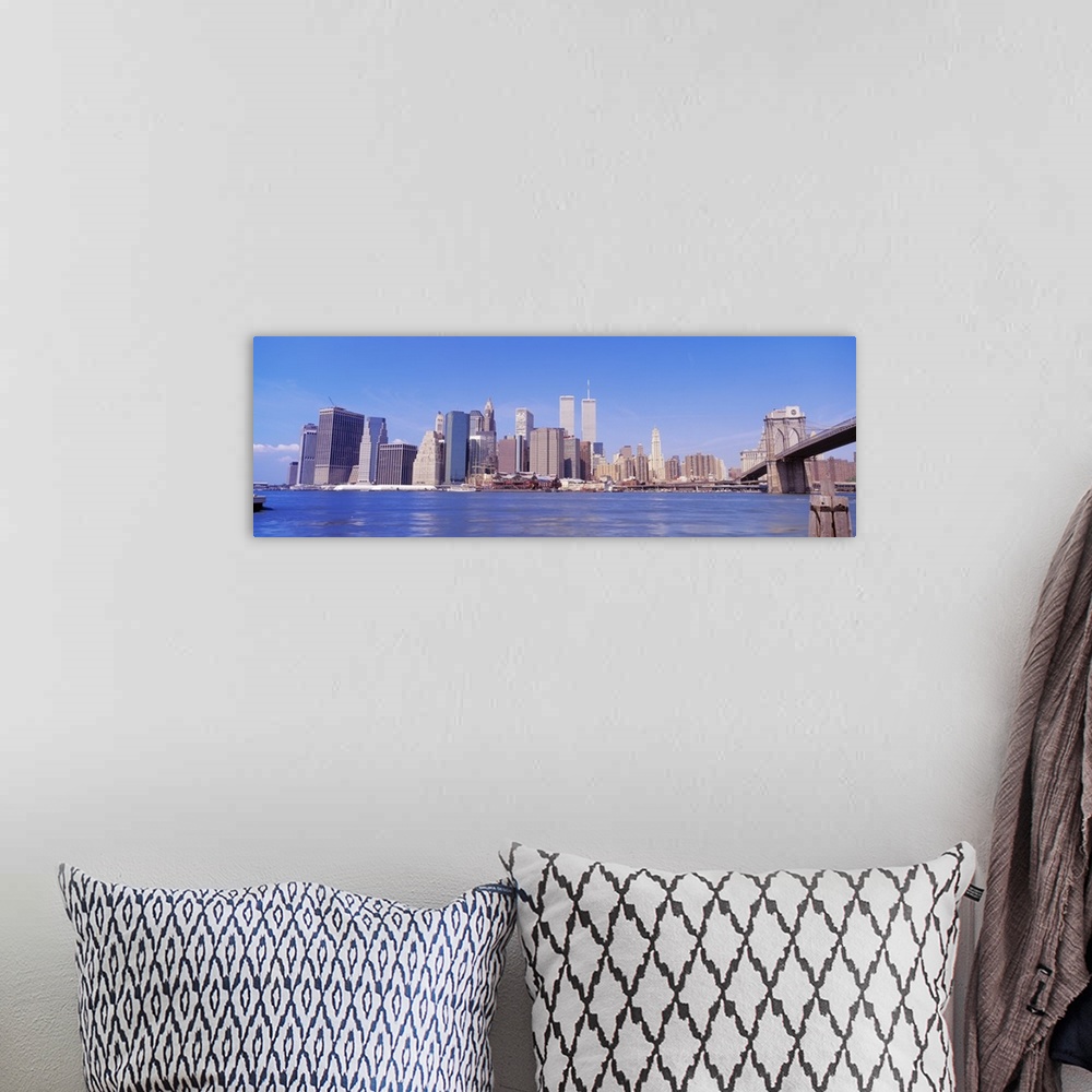 A bohemian room featuring Long panoramic photo of the NYC cityscape with the Twin Towers.