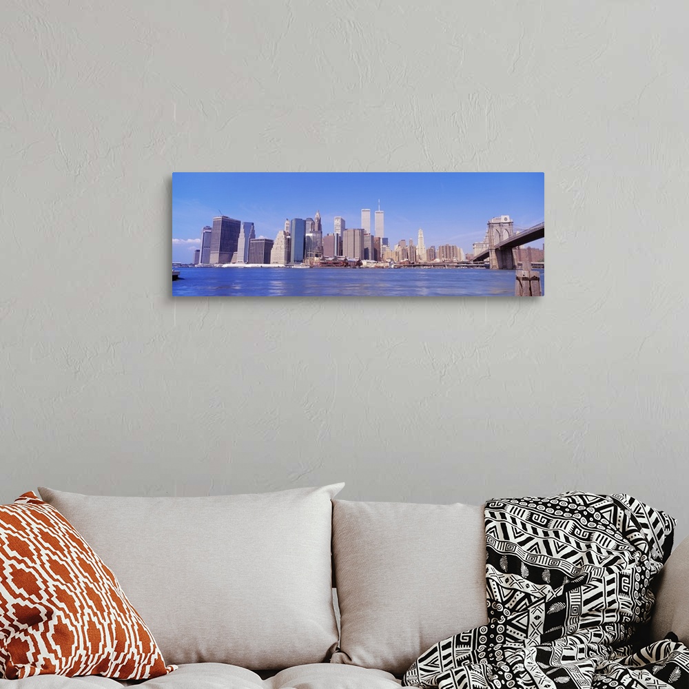 A bohemian room featuring Long panoramic photo of the NYC cityscape with the Twin Towers.