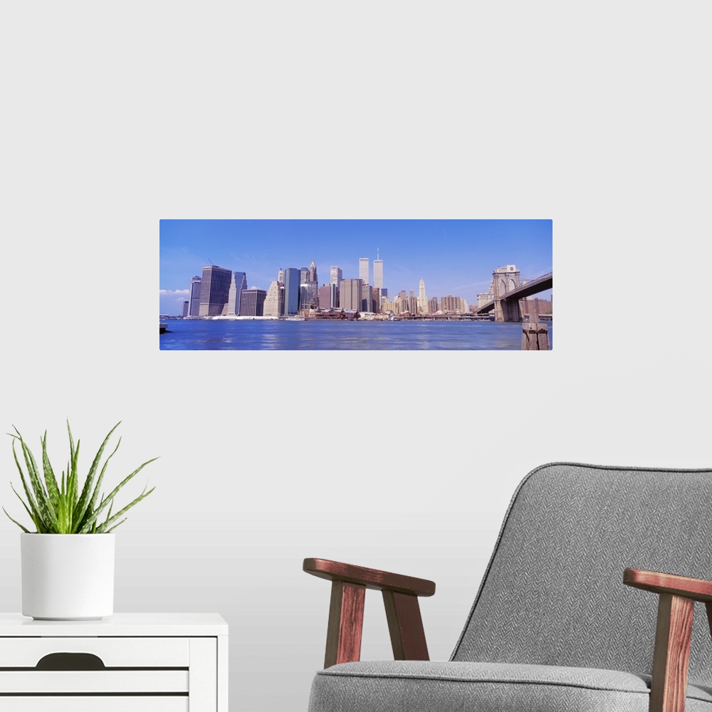 A modern room featuring Long panoramic photo of the NYC cityscape with the Twin Towers.