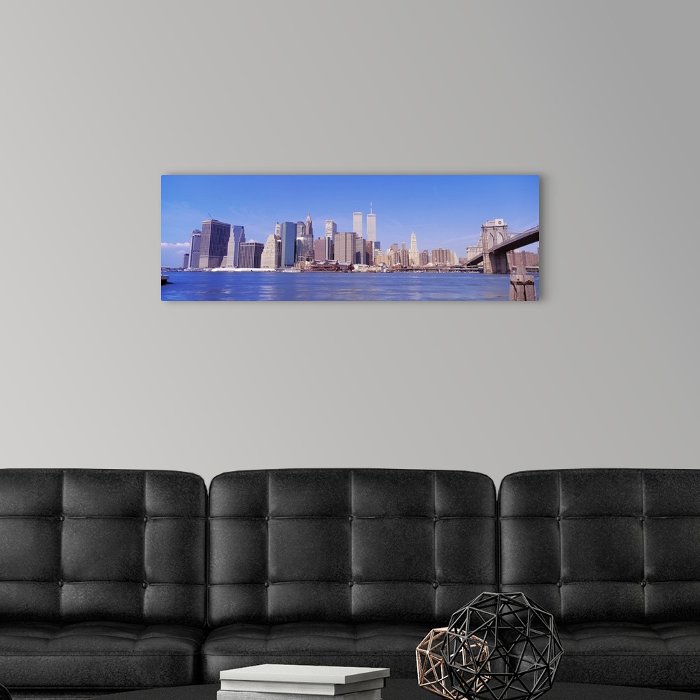 A modern room featuring Long panoramic photo of the NYC cityscape with the Twin Towers.