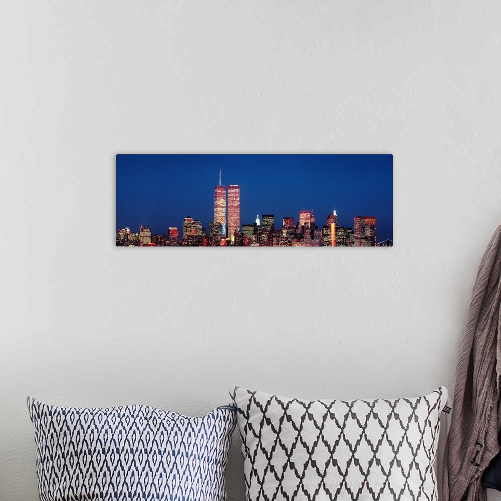 A bohemian room featuring Giant panoramic photograph of New York City skyscrapers at night, including the World Trade Center.