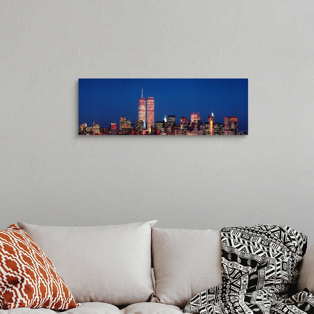 A bohemian room featuring Giant panoramic photograph of New York City skyscrapers at night, including the World Trade Center.