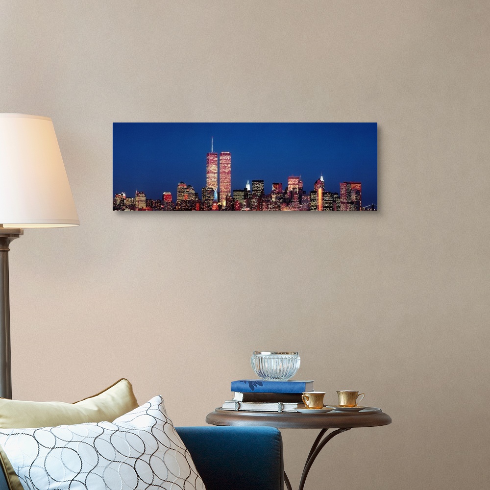 A traditional room featuring Giant panoramic photograph of New York City skyscrapers at night, including the World Trade Center.