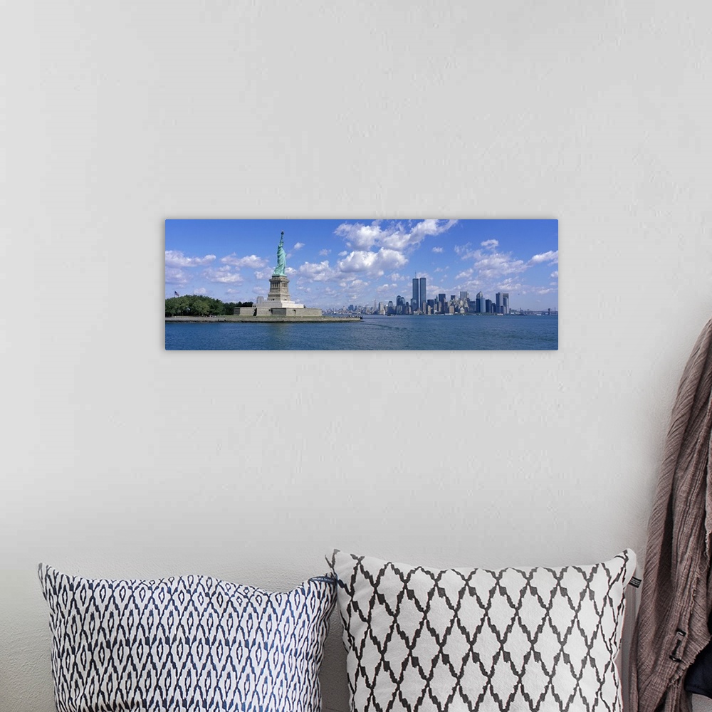 A bohemian room featuring Panoramic picture taken from a distance of the NYC skyline with Ellis Island and the Statue of Li...