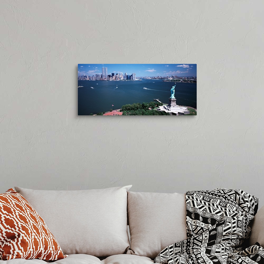 A bohemian room featuring Big, horizontal photograph of the Statue of Liberty and the New York Harbor.  The New York City s...