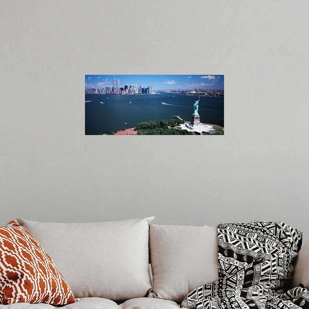 A bohemian room featuring Big, horizontal photograph of the Statue of Liberty and the New York Harbor.  The New York City s...