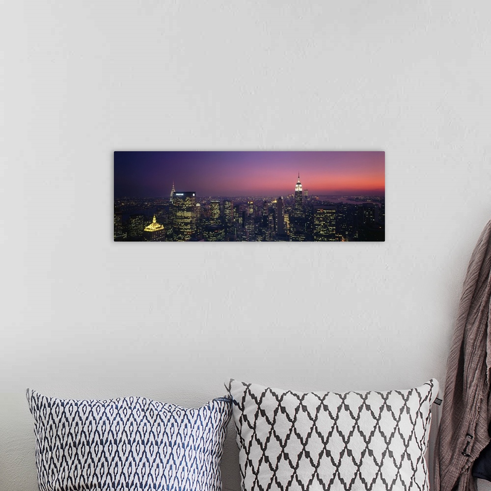 A bohemian room featuring Aerial view of New York City at late dusk with lit up office buildings, the Chrysler Building, an...