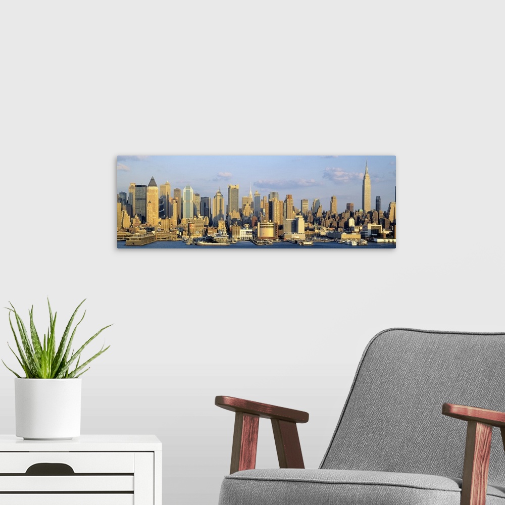 A modern room featuring Panoramic photograph shows the daytime skyline of a busy city within the Northeastern United Stat...