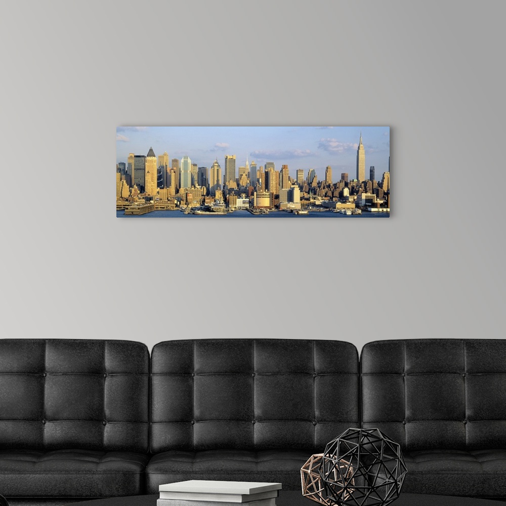 A modern room featuring Panoramic photograph shows the daytime skyline of a busy city within the Northeastern United Stat...