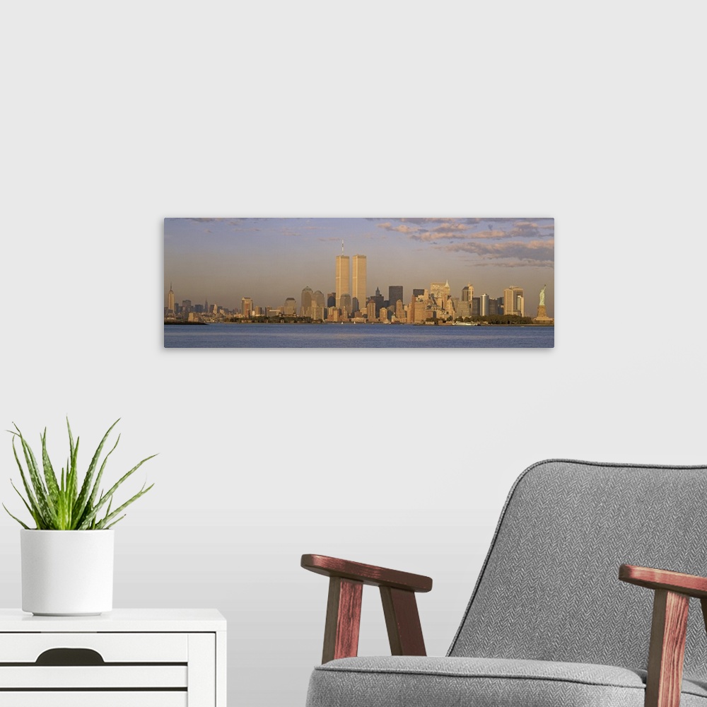 A modern room featuring Panoramic image of the NYC skyline with the Twin Towers at sunset.