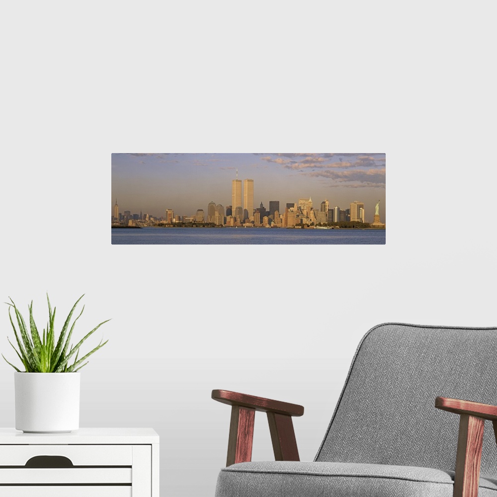 A modern room featuring Panoramic image of the NYC skyline with the Twin Towers at sunset.