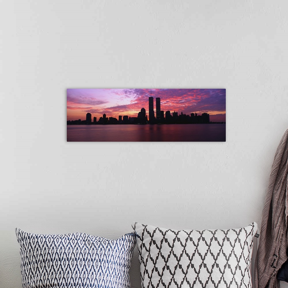 A bohemian room featuring Dramatic photograph of the New York City skyline at sunset, with the World Trade Center towers si...