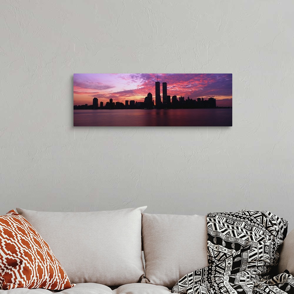 A bohemian room featuring Dramatic photograph of the New York City skyline at sunset, with the World Trade Center towers si...