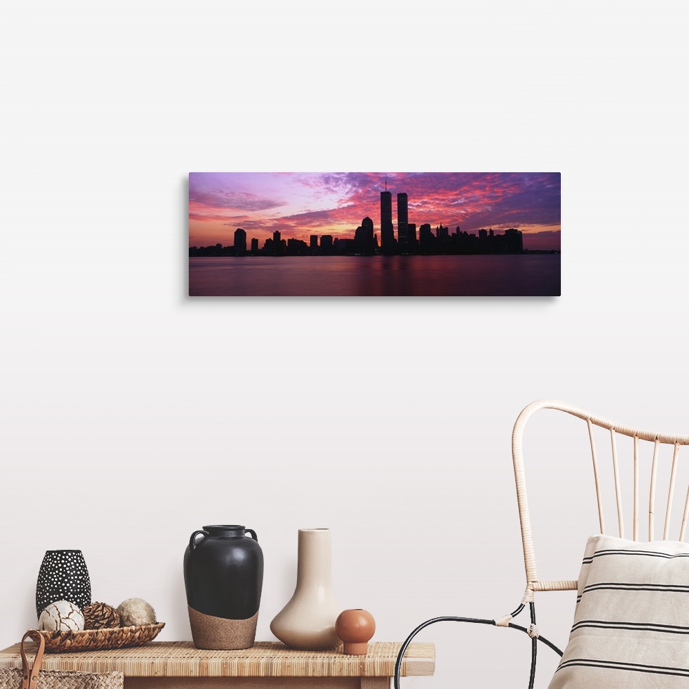 A farmhouse room featuring Dramatic photograph of the New York City skyline at sunset, with the World Trade Center towers si...