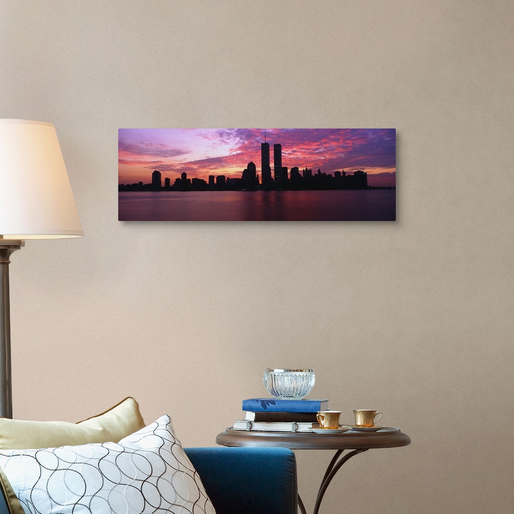 A traditional room featuring Dramatic photograph of the New York City skyline at sunset, with the World Trade Center towers si...