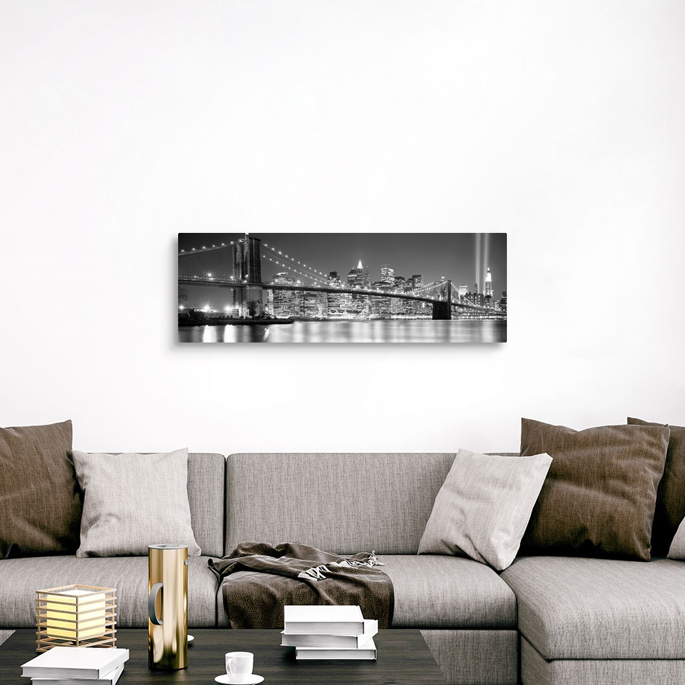 A traditional room featuring A panoramic landscape photo taken after 2001 of Manhattan and Brooklyn Bridge shining bright over...